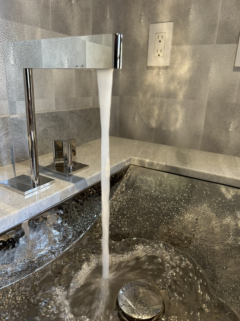 modern-bathroom-faucet-water-flow-southington-ct.jpg Modern bathroom faucet with water flowing into sink in Southington, CT — clean and stylish plumbing fixture installed by Charter Oak Plumbing.